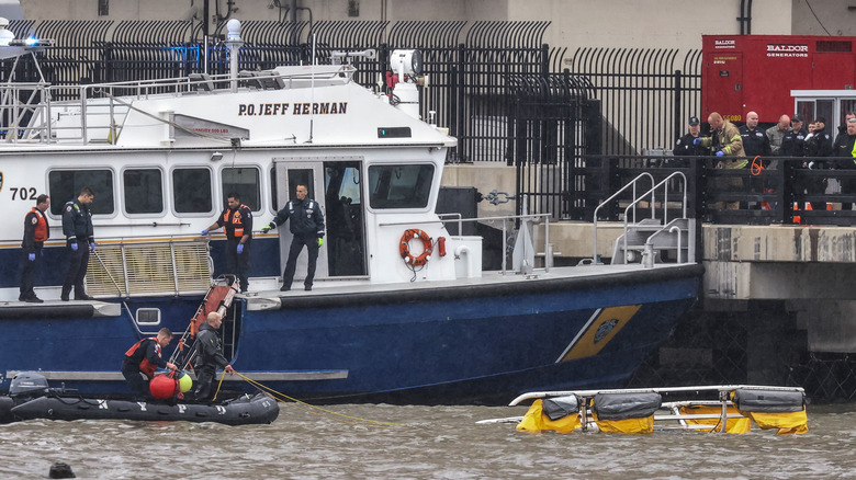 Rescue workers respond to the crash site of a helicopter in the Hudson River on April 10, 2025 in Jersey City, New Jersey.